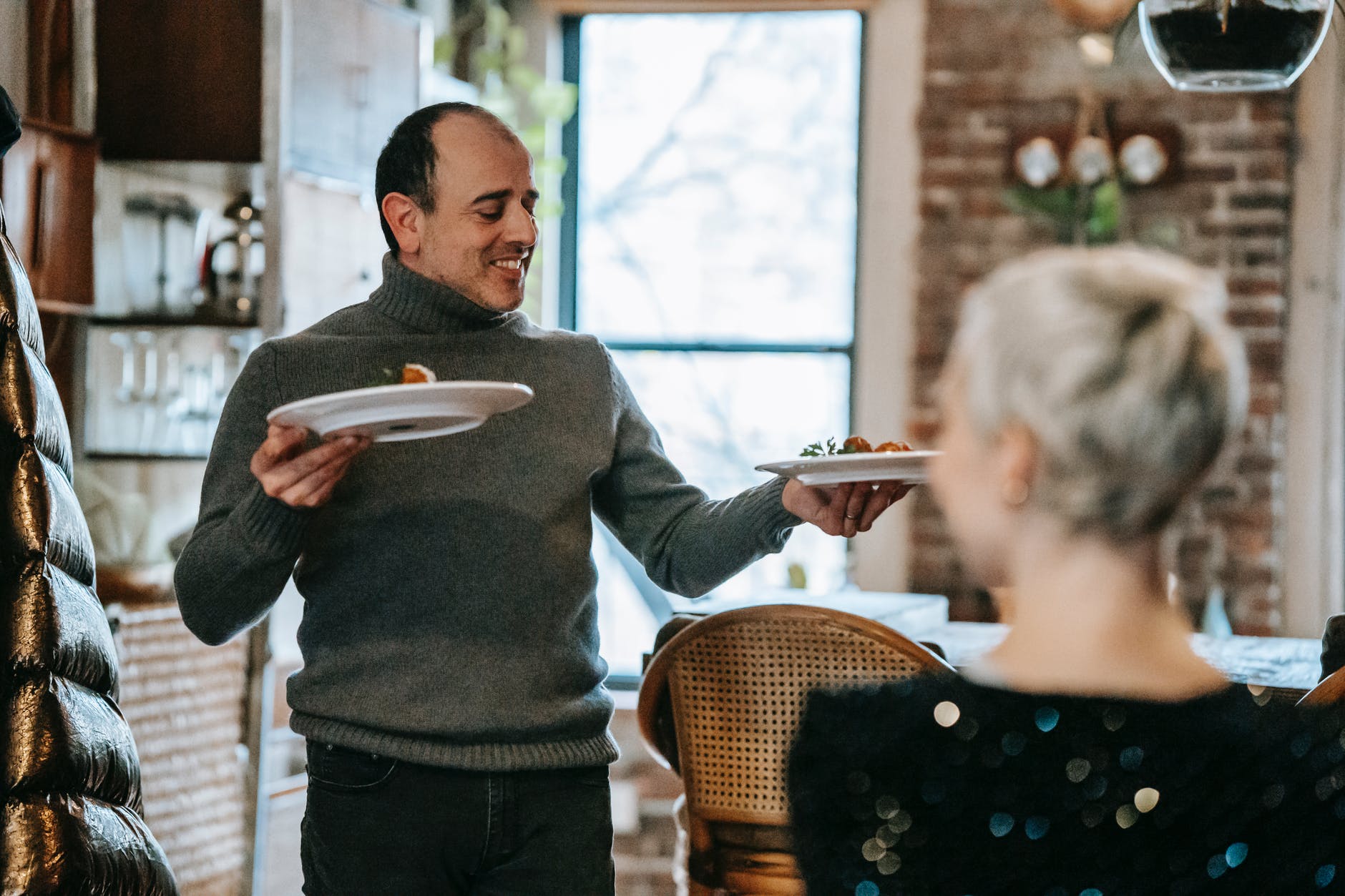 smiling couple having date with dish in restaurant