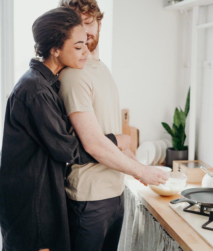photo of woman hugging her man