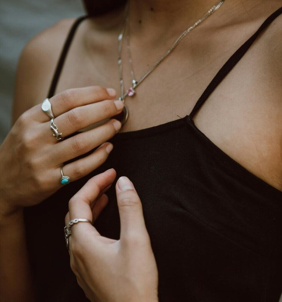 young woman showing accessories on hands and neck