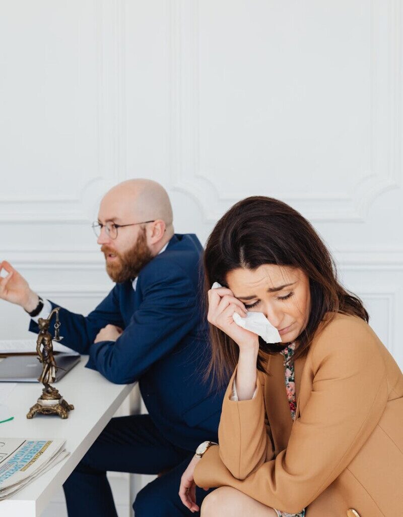 a couple in mediation hearing in a law office